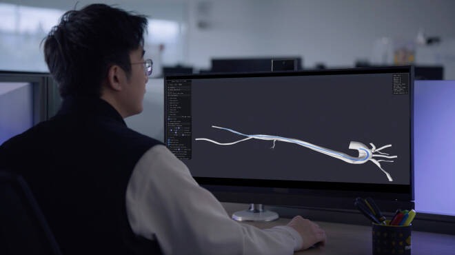 A surgeon using simulation on a computer to place a catheter.